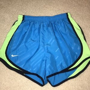 Blue and green Nike running shorts